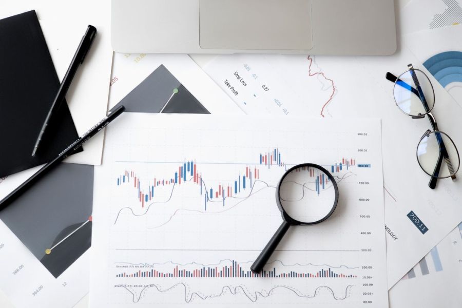 Charts and a magnifying glass on a desk