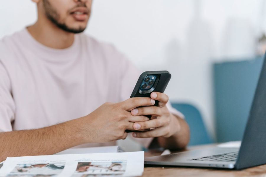 Person searching for a local business on their phone at a desk