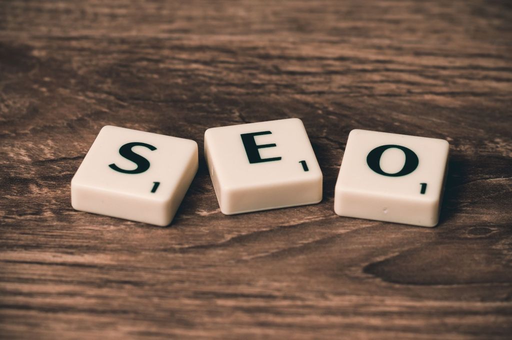 The letters SEO spelled out in wooden tiles