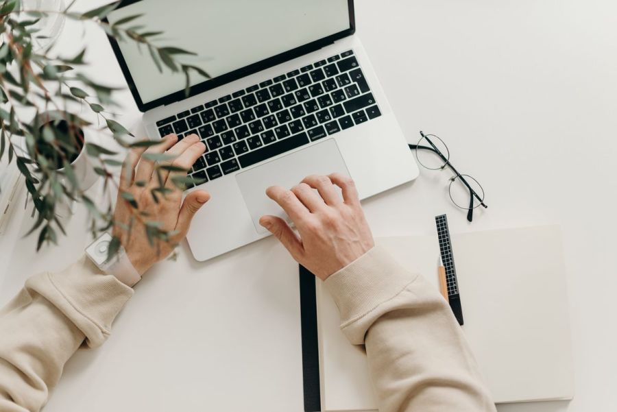 Writer typing content on a laptop